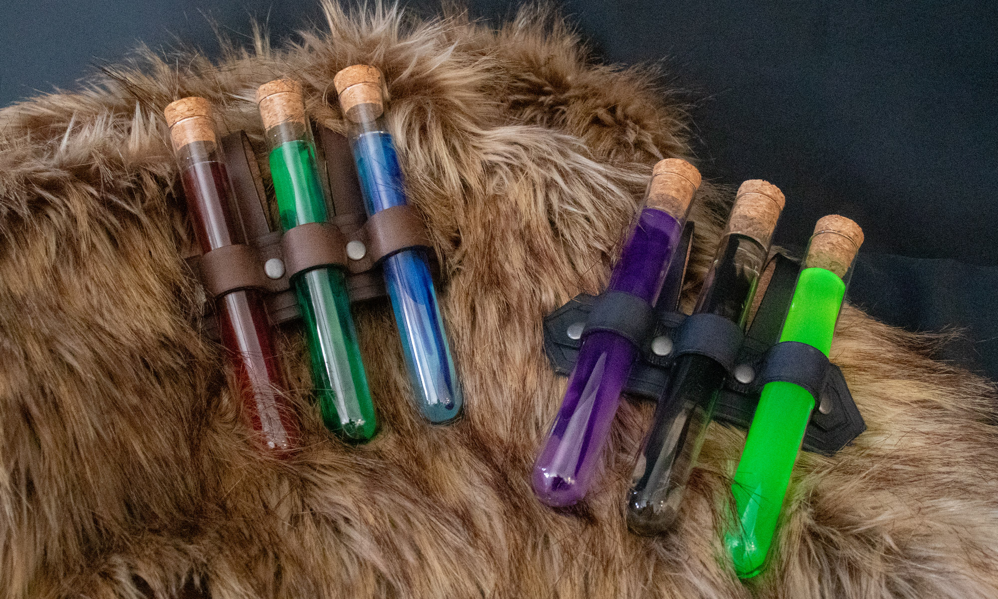 Two leather belt holsters with "triple" potions. Left: Dark brown leather with red, green, and blue potions. Right: Black leather holster with purple, clear with black swirl, and neon geen potions.