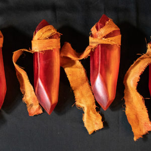 Four Red Sign Soapstone props, seen sitting in a row on a table from above