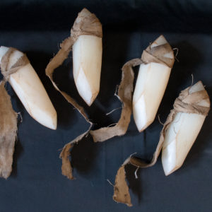 Four white sign soapstone dark souls props, sitting on a black background.