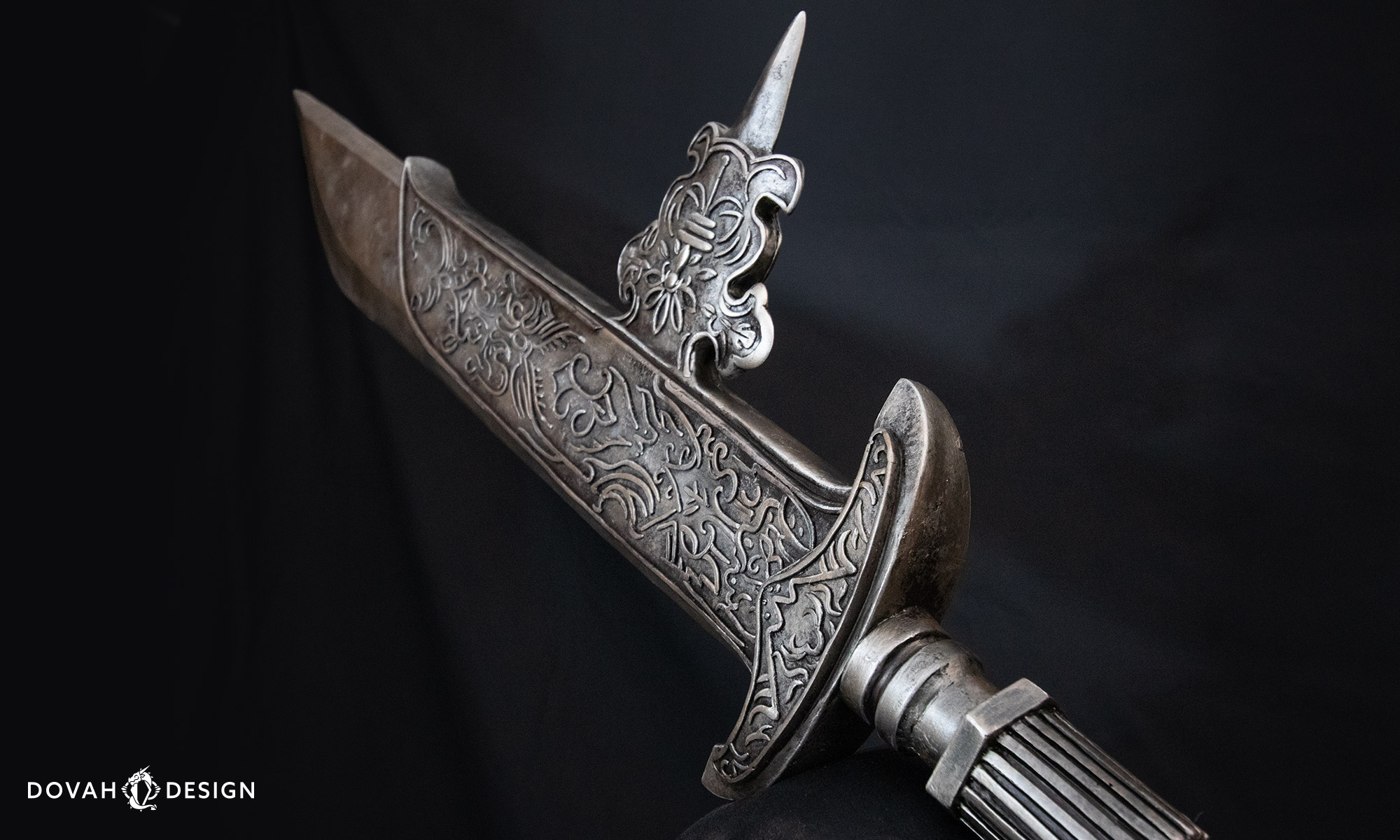 Angled detail view of the Black Knight halberd cosplay prop blade, in front of a black background.