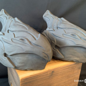 Two raw resin casts of the Helm of Artorias. Posed on a wooden crate, facing right.