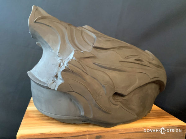 Single resin cast of the Helm of Artorias, unfinished straight out of the mold. Posed on a wooden crate, facing right with the back semi visible.