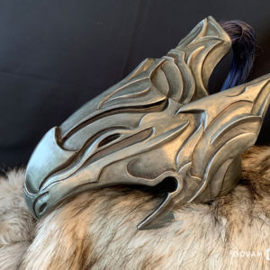 Finished resin cast helmet of Knight Artorias, made by Dovah Design. Helmet sitting on top of white fur padding, faced left with the blue wig hair behind.