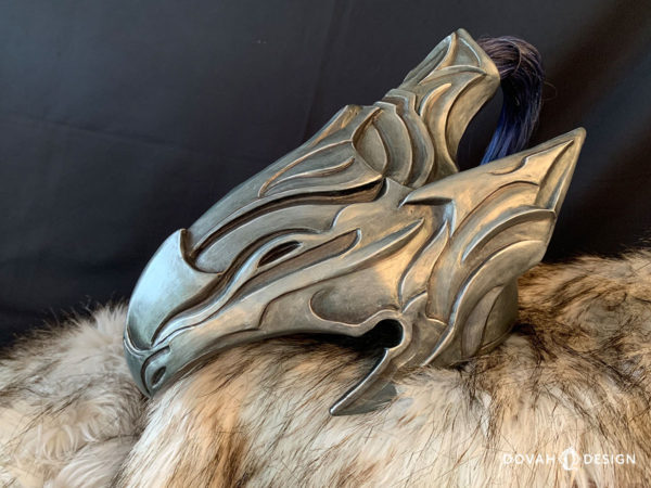 Finished resin cast helmet of Knight Artorias, made by Dovah Design. Helmet sitting on top of white fur padding, faced left with the blue wig hair behind.