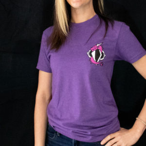 Close up of the purple dovah design t-shirt worn by Sam, posing with hand on hip in front of a black background.