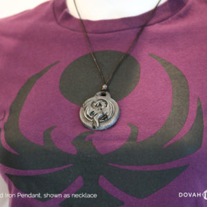 Distressed iron necklace of the Elder Scrolls: Online Elsweyr logo. Shown as a necklace on display mannequin. Logo depecits a drake (dragon) symbol, purposely aged to look like old treasure.