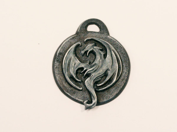 Shiny steel pendant of the Elder Scrolls Online Elsweyr logo.