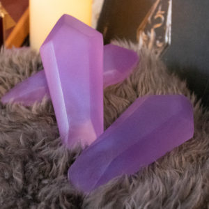 Three common soul gem props, colors slightly varied, resting on gray fur on a Skyrim-themed set.