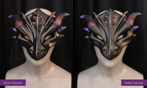 Glossy and Matte "Rainbow Horned" masquerade style dragon masks, shown side by side tied to female mannequin busts on black background