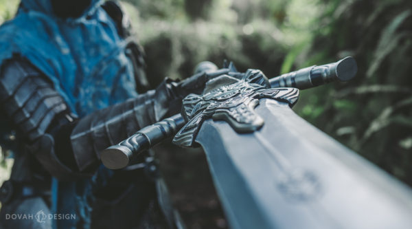 Greatsword of Artorias prop, blade pointing at the camera with top view of the hilt details.