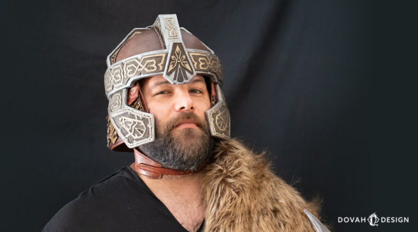 Model Billy wearing Lord of the Rings Dwarf (Gimli) helmet, facing toward the camera on a black background.