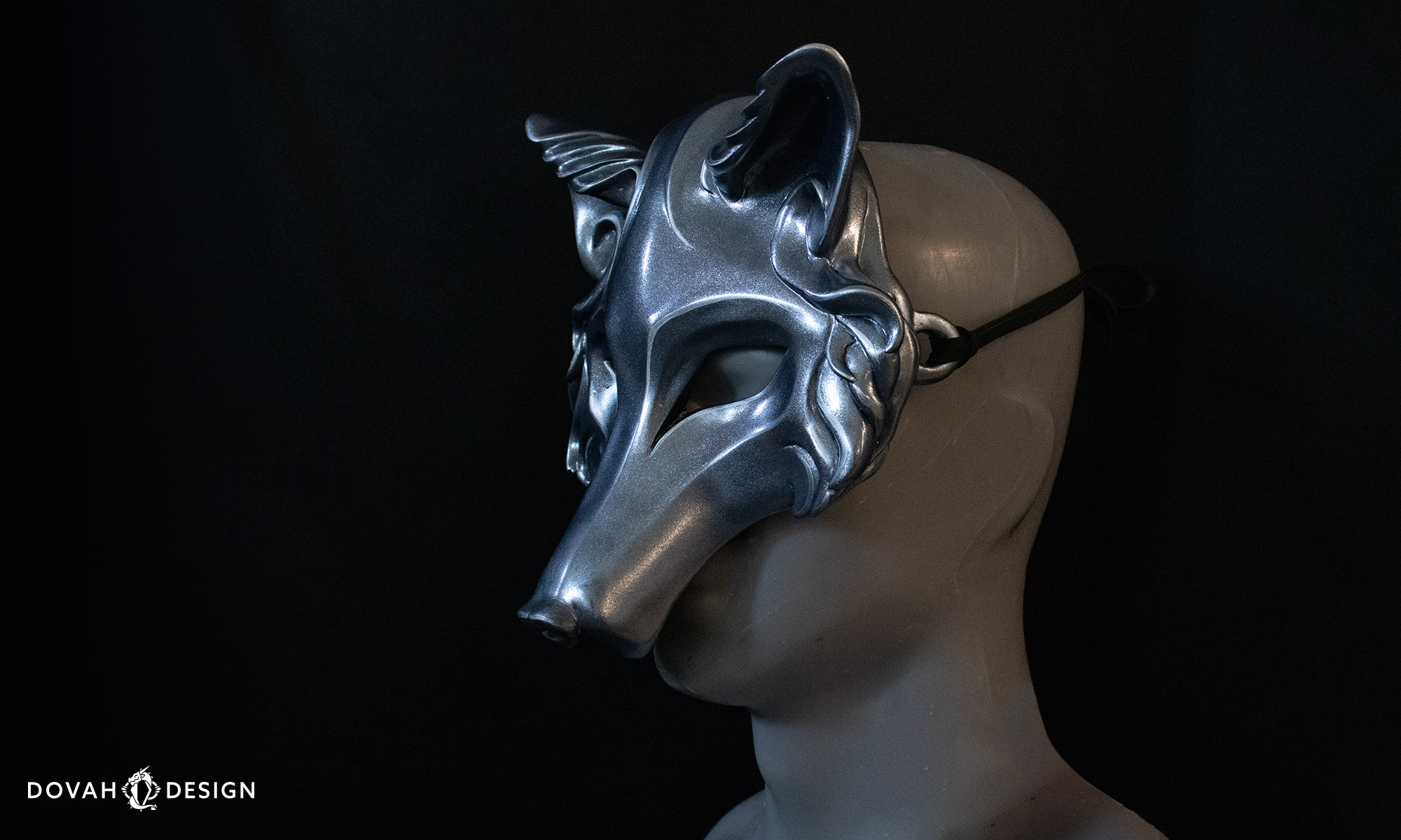 Silver "iron" Masquerade wolf mask posed on a gray mannequin bust in front of a black background at 3/4 angle.